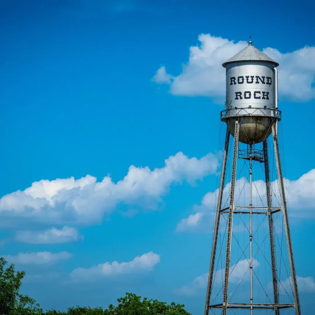 Round Rock water tower against a blue sky