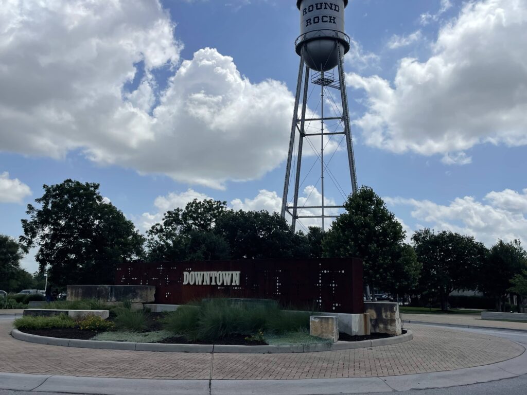 Image of Downtown Round Rock with the water tower overlooking the city where Alpha Team Roofing serves